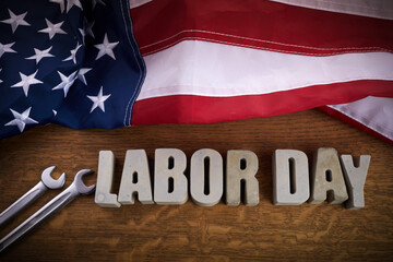Fototapeta na wymiar Happy Labor Day banner. USA flag and letters on rustic wooden background.