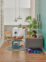 Man washing clothes in the room, decorative home style, washing machine.