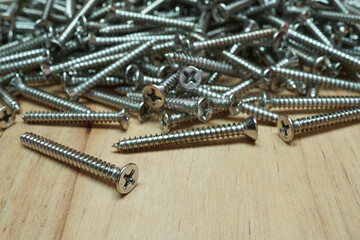 Metal screws on wooden table, Accessories material of the carpentry