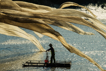 A fisherman hangs giant fishing nets to dry in Xiapu, China's Fujian province