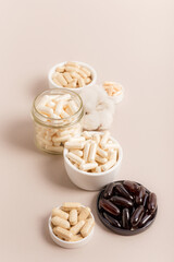 Organic natural dietary supplements, vitamins and minerals on brown background in rustic composition. Vitamins and medications for health support. Organic health care products. Nutritional supplements