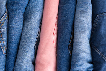 a pile of blue and pink jeans Close up