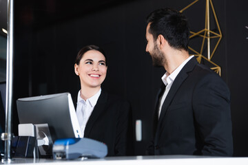 happy administrators looking at each other in front desk