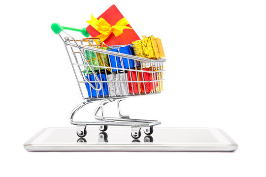 A shoppingcart consisting of giftboxes and giftcard kept on mobilephone.