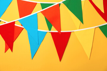Buntings with colorful triangular flags on orange background