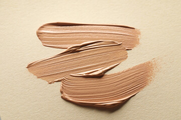 Sample of liquid skin foundation on beige background