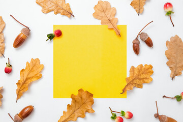 Oak leaves and acorns pattern on white background. Yellow blank frame for text. Autumn mockup. Minimal Autumn composition, fall concept. Flat lay, top view and copy space