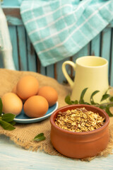 Fototapeta premium Granola and eggs on rural rustic background, healthy eating, wellbeing, healthy lifestyle, breakfast in the morning