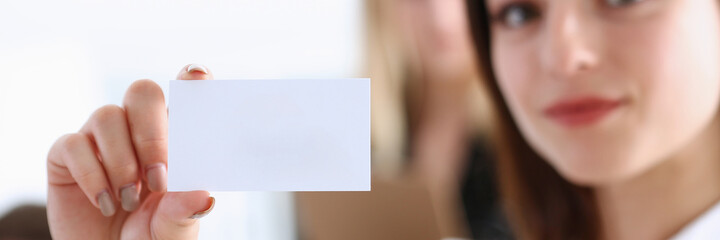 Smiling Businesswoman in suit hold in hand business card