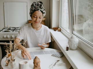 woman with tarot cards on the white kitchen