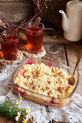 Peach and plum streusel pie. Walnuts, tea, chamomile, side view, wooden background, rustic.