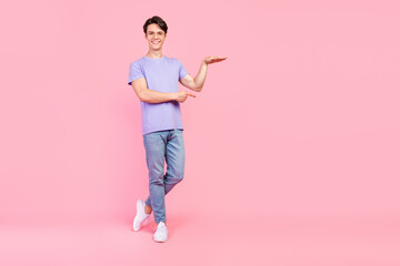 Full length body size view of attractive cheerful guy showing copy blank space ad size isolated...