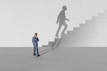 Career. Businessman is planning a career growth, the shadow symbolizes thoughts