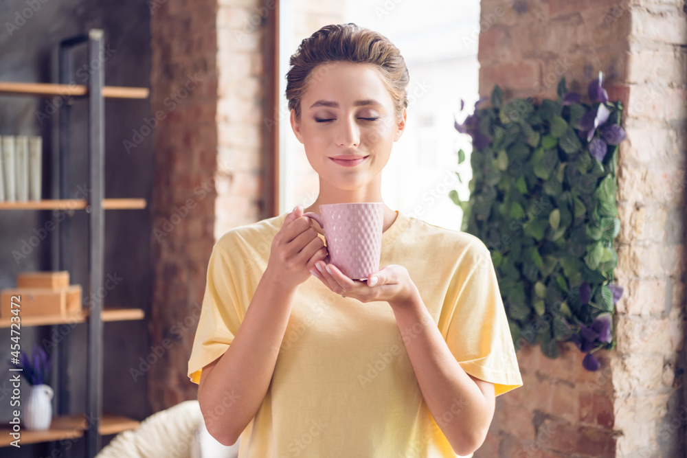 Sticker Photo of calm peaceful charming young woman smell coffee drink cup morning indoors inside house home