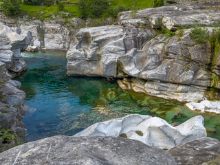 wild rock formation of mountain riverbed with clear turquoise water Verzasca, Switzerland