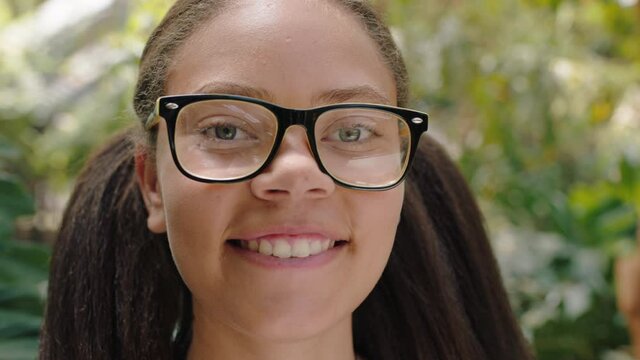 portrait african american teenage girl smiling happy in nature outdoors wearing glasses 4k footage