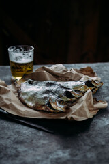 Dried fish on the table close-up. Taranka with beer