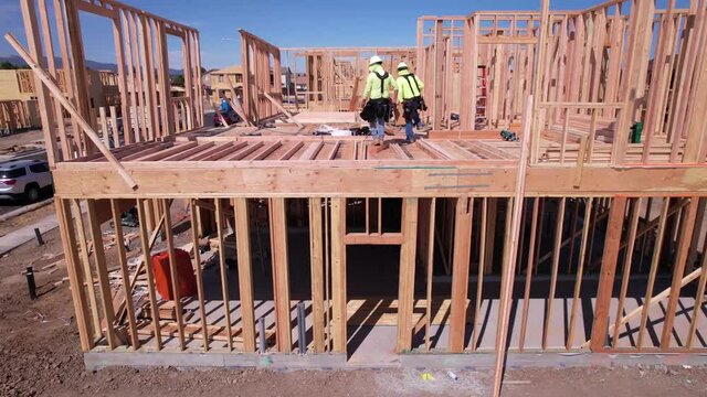 A 4K video of builders working at the construction site on a sunny day