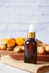 Obraz premium bottle of ginger oil on table 