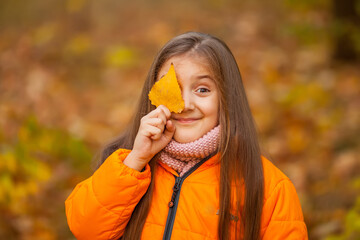 autumn outdoor portrait of beautiful happy child girl