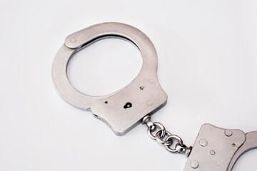 gray metal handcuffs on a white background.
