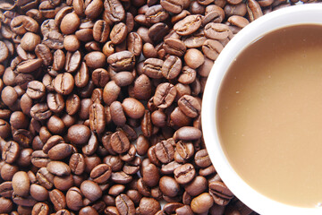 Close up of fresh coffee beans and coffee on table 