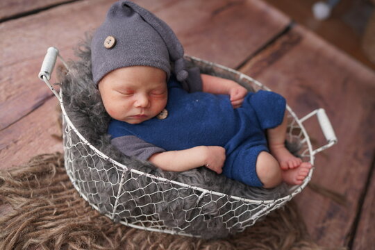 Sleeping newborn boy in the first days of life. Newborn photo session.