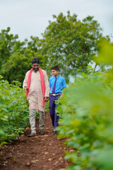 Indian farmer with his son at agriculture field