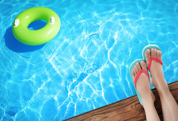 Woman wearing stylish flip flops near swimming pool, above view