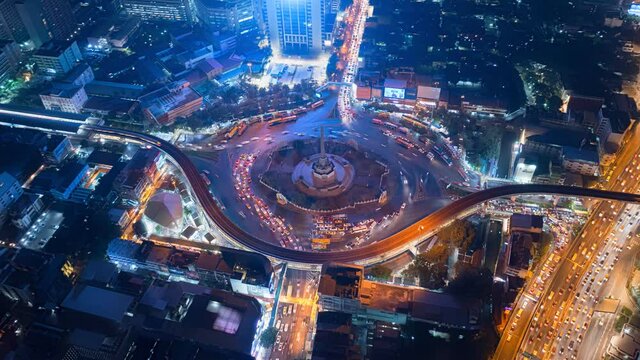 Aerial view of huge roundabout and traffic lights at Victory Monument during the night time. Landmark of Bangkok, Thailand
