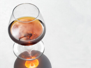 Close-up of glass with cognac on a white background