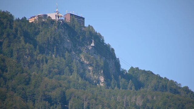 Famous Vogel lift above lake Bohinj, Slovenia. Telephoto perspective of cable way ascending. Cable car transporting people. Static shot, sped up, time lapse