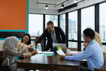 Confident businessman standing congratulate to multicultural corporate colleagues at meeting room in the modern office. diverse corporate colleagues.