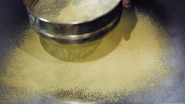 Cook makes pizza with corn flour in Italian restaurant kitchen, filmed from above