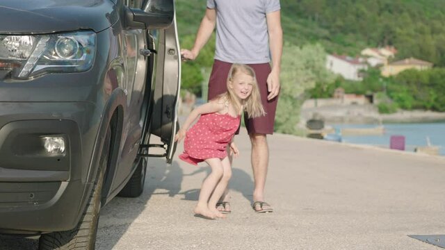 Slow motion - Little girl jumping out of car