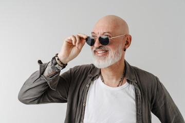 Bald european man in sunglasses laughing and looking aside