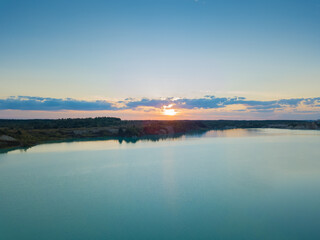 Drone view of a beautiful, amazing sunset on the chalk quarries in the summer near Krichev, Belarus