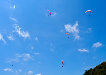 Medellin, Colombia - 20.05.2015: Paragliders flying above Medellin