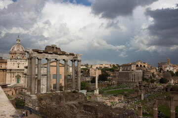 Top view of the Roman Forum against a dramatic sky. Ancient architecture and the urban landscape of historical Rome.