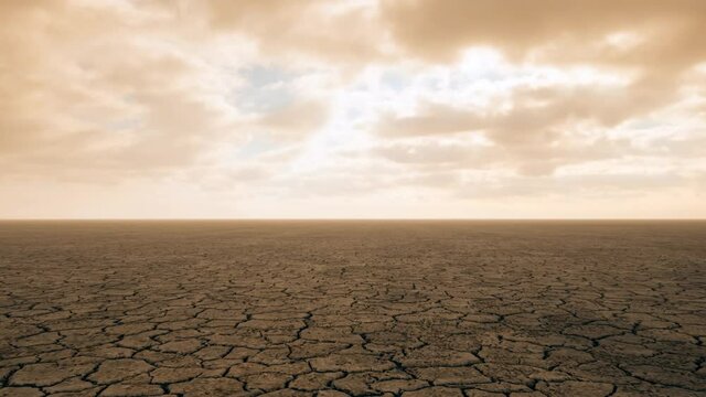 An aerial view over once vibrant agricultural lands, now cracked, dry and barren due to severe droughts from the effects of climate change.