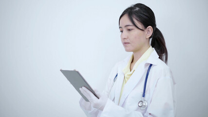 Female doctor  touch tablet screen searching report or disease information.