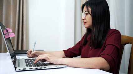 Fototapeta premium Woman working at home with loptop