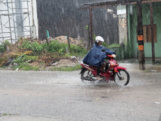 Moped driving during a storm in Leticia, Colombia