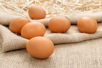 Fresh brown eggs on burlap