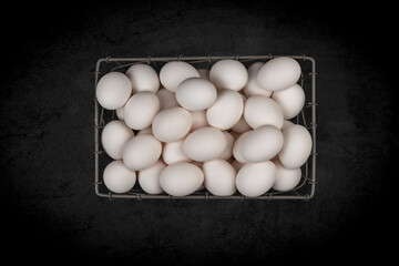 Basket of fresh white eggs.