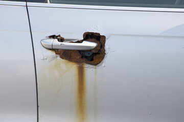 Rusty right wing covered with corrosive defect of iron