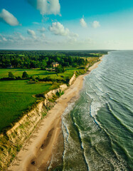 Aerial Top view shot of an empty sand beach Sand Sea Shore with a wave and white foamy, summer background - obrazy, fototapety, plakaty