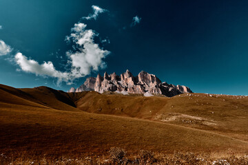 Dramatic sky and landscape image surrounding rock mountain and valley