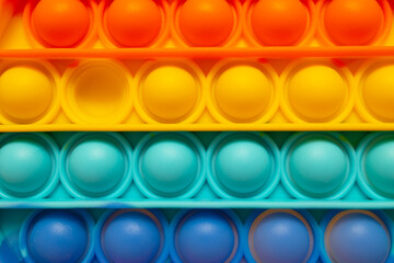 Rainbow pop it fidget toy background, closeup