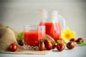 homemade freshly squeezed tomato juice with pulp in a glass decanter